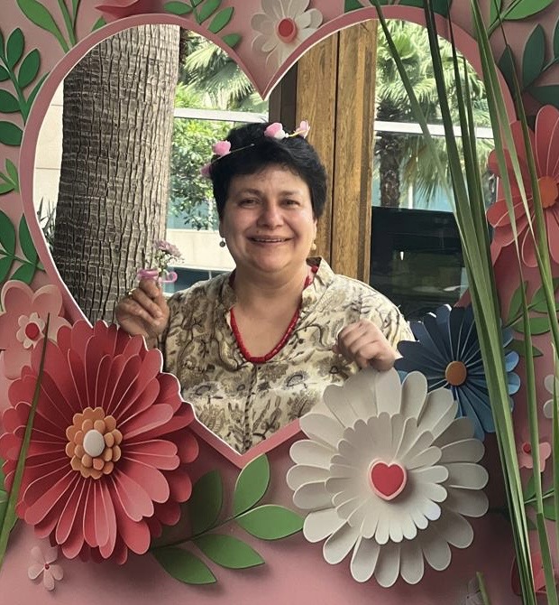 Rachana smiling inside a heart-shaped floral frame